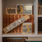 Ein Bücherregal mit alten Büchern und eine geöffnete Schachtel Archivist | 'Land der Träume' Streichhölzer von Archivist Gallery - lange Streichhölzer mit Goldfolienmond und Buchmotiven - sind ein einzigartiges Geschenk für jeden Bücherliebhaber.