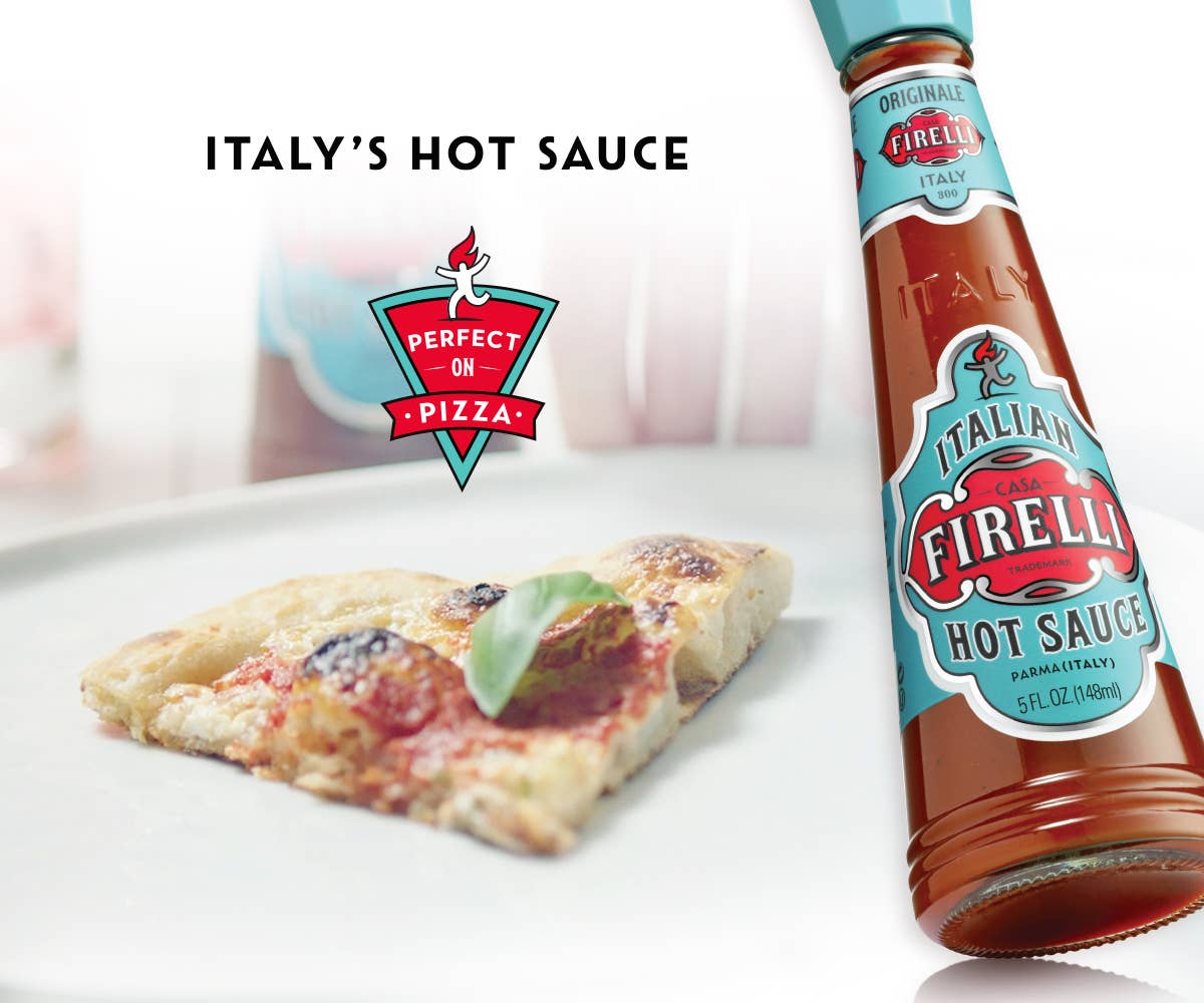 Eine Pizzascheibe mit Basilikum sitzt neben einer Flasche Firelli | Italienische scharfe Soße 148 ml. Der Text lautet ITALIENISCHE SCHARFE SOßE mit dem Aufkleber "Perfekt auf Pizza". Der Hintergrund ist hell und leicht verschwommen.