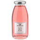 Eine klare Glasflasche, gefüllt mit rosa Rosensirup, verschlossen mit einem silbernen Verschluss. Auf dem Etikett ist die Marke L.W.C. Michelsen abgebildet und die Aufschrift „Gourmet Sirup Rose 250 ml“ zu lesen, was die gleiche Eleganz widerspiegelt wie die renommierte Kollektion des Unternehmens.