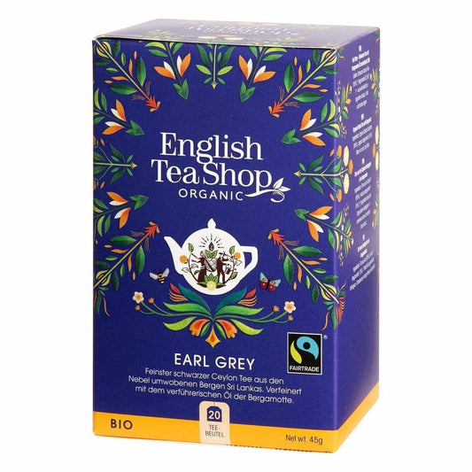 Eine blaue Schachtel von English Tea Shop ETS | Earl Grey BIO Fairtrade mit 20 Teebeuteln ist mit Blumenmotiven und einer Teekannen-Illustration verziert und trägt sowohl das Fairtrade- als auch das Bio-Siegel. Die Packung enthält 20 Teebeutel.