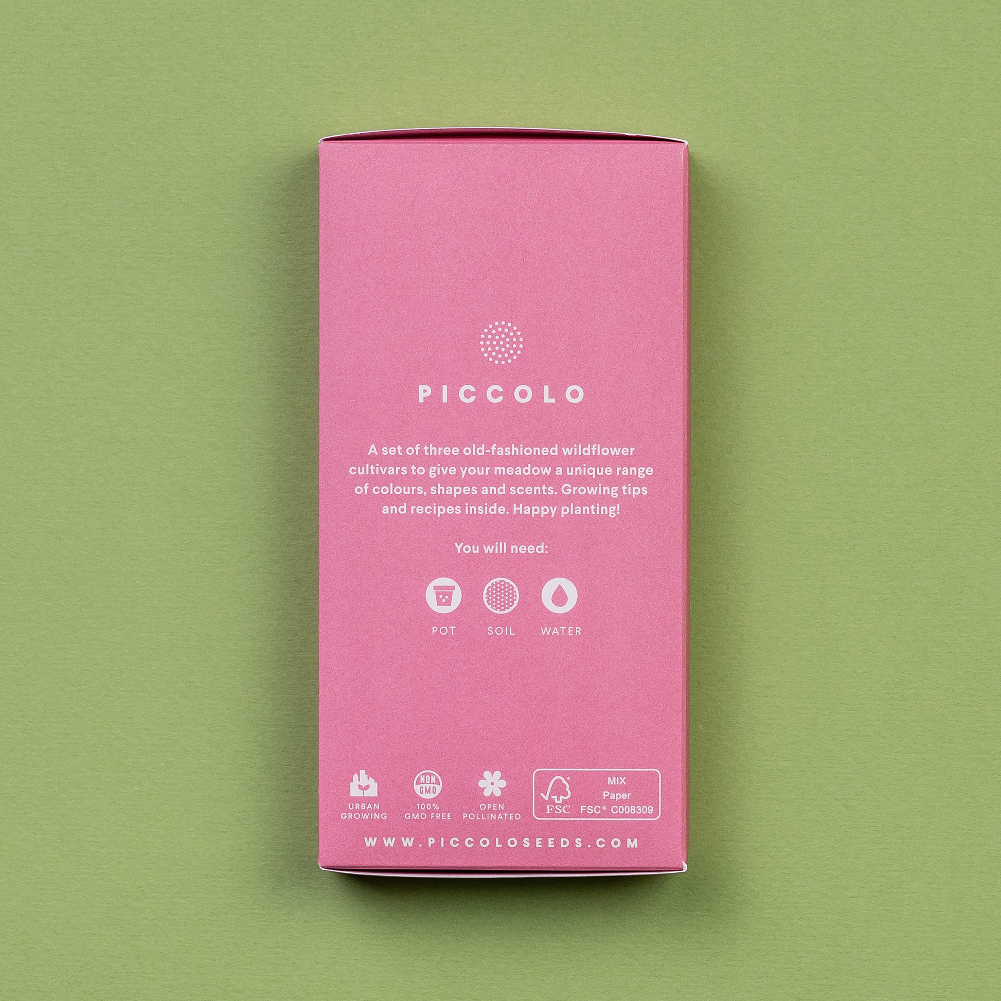 Eine rosafarbene rechteckige Packung von Piccolo Seeds (Alte Blumenwiese, Deluxe-Kollektion) mit weißem Text und grünen Symbolen für Topf, Erde, Wasser. Beschriftete Wildblumensamen mit Pflanzanleitung - Gentechnikfrei.