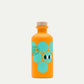 Eine leuchtend orangefarbene 200-ml-Flasche von yiayia and friends mit einem Holzdeckel, türkisfarbenen Kreisen und augenähnlichen Motiven, beschriftet mit "Weißer Balsamico-Essig" - ideal für Vinaigretten oder Salate.