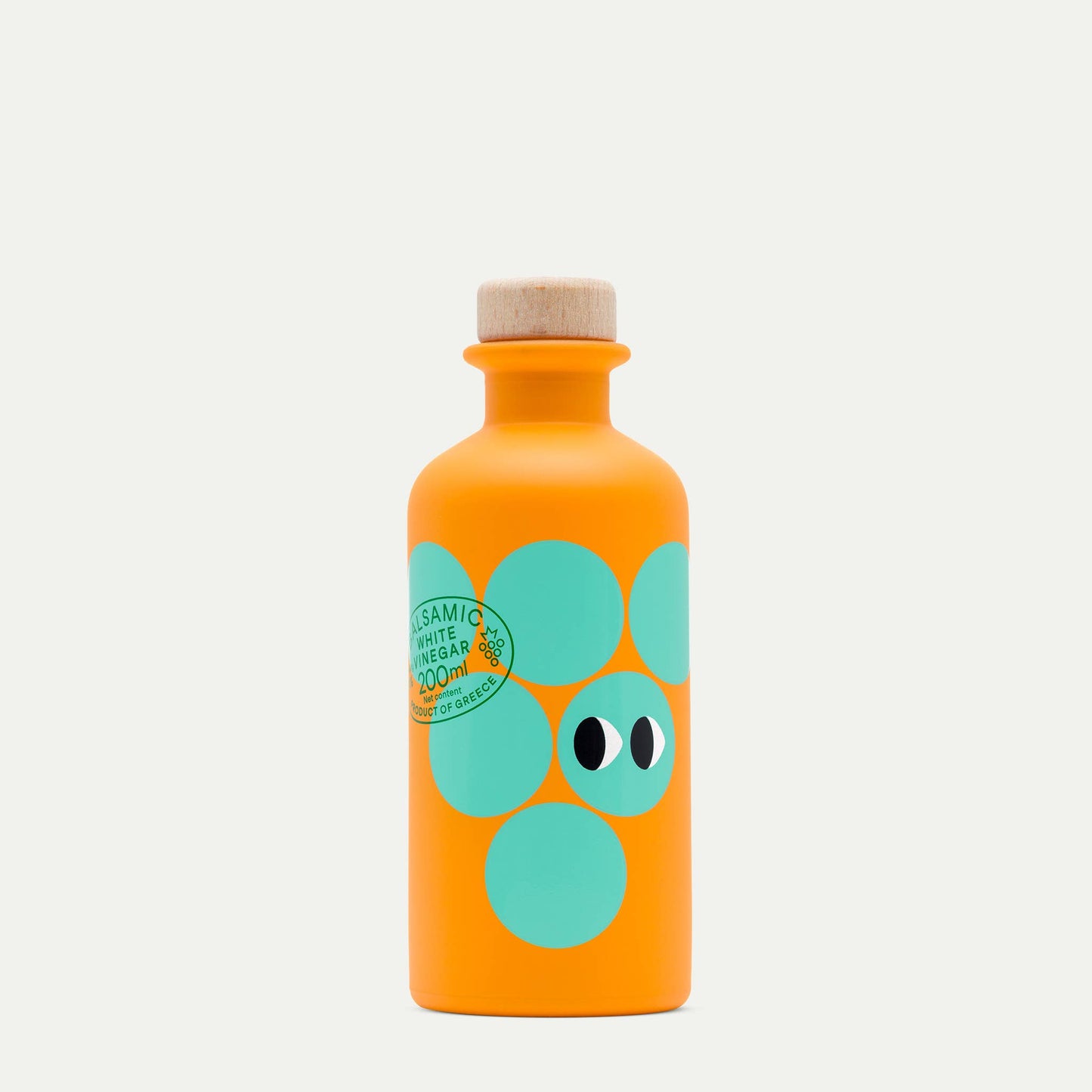 Eine leuchtend orangefarbene 200-ml-Flasche von yiayia and friends mit einem Holzdeckel, türkisfarbenen Kreisen und augenähnlichen Motiven, beschriftet mit "Weißer Balsamico-Essig" - ideal für Vinaigretten oder Salate.