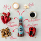 Eine Flasche Firelli | Extra scharfe italienische Sauce 148 ml ist umgeben von italienischem Meersalz, Knoblauch, Balsamico-Essig, geröstetem roten Pfeffer, Steinpilzen und kalabrischen Chilischoten - ideal für Grillfleisch.