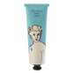 Eine Tube der Kokosnuss"-Handcreme von Archivist Gallery zeigt ein blau-weißes Design mit der Linienzeichnung einer Frau und dem Text Göttliche Handcreme Kokosnuss" und verströmt einen unwiderstehlichen Kokosnussduft.