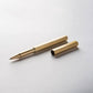 Ein goldener, sechseckiger YSTUDIO Klassischer Revolve-Rollerball-Stift (Messing) von ENTREPÔT, Kappe entfernt und daneben auf einer weißen Fläche platziert - entworfen für sanftes Schreiben und stabilen Griff.