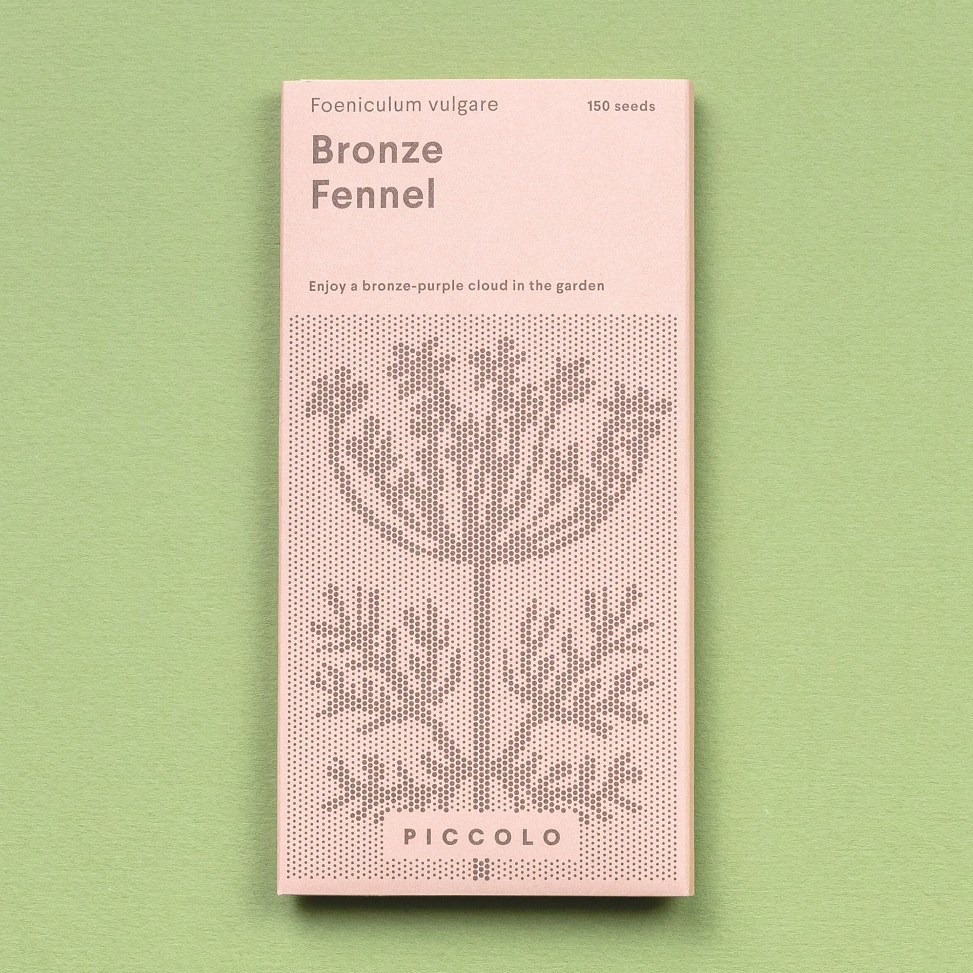 Eine rosafarbene Piccolo Seeds-Packung mit der Aufschrift "Fenchelbronze" zeigt eine gepunktete Illustration der Gewürzpflanze, listet 150 Fenchelsamen auf und steht auf einem hellgrünen Hintergrund.