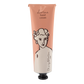 Eine pfirsichfarbene und weiße Tube der Archivist Gallery Kirschblüte" Handcreme zeigt eine schwarze Strichzeichnung eines Frauengesichts und den Produktnamen in vertikaler Schrift auf der unteren Hälfte.
