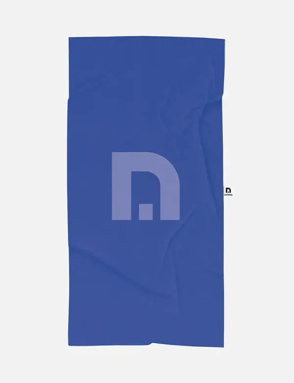 Das Notabag | 'Flow' Handtuch (78 x 160 cm) ist ein blaues rechteckiges Handtuch mit einem minimalistischen grauen geometrischen Design, hergestellt aus recyceltes Material. Schnell trocknend, verfügt es über ein kleines weißes Etikett auf der rechten Seite. Marke: Notabag.