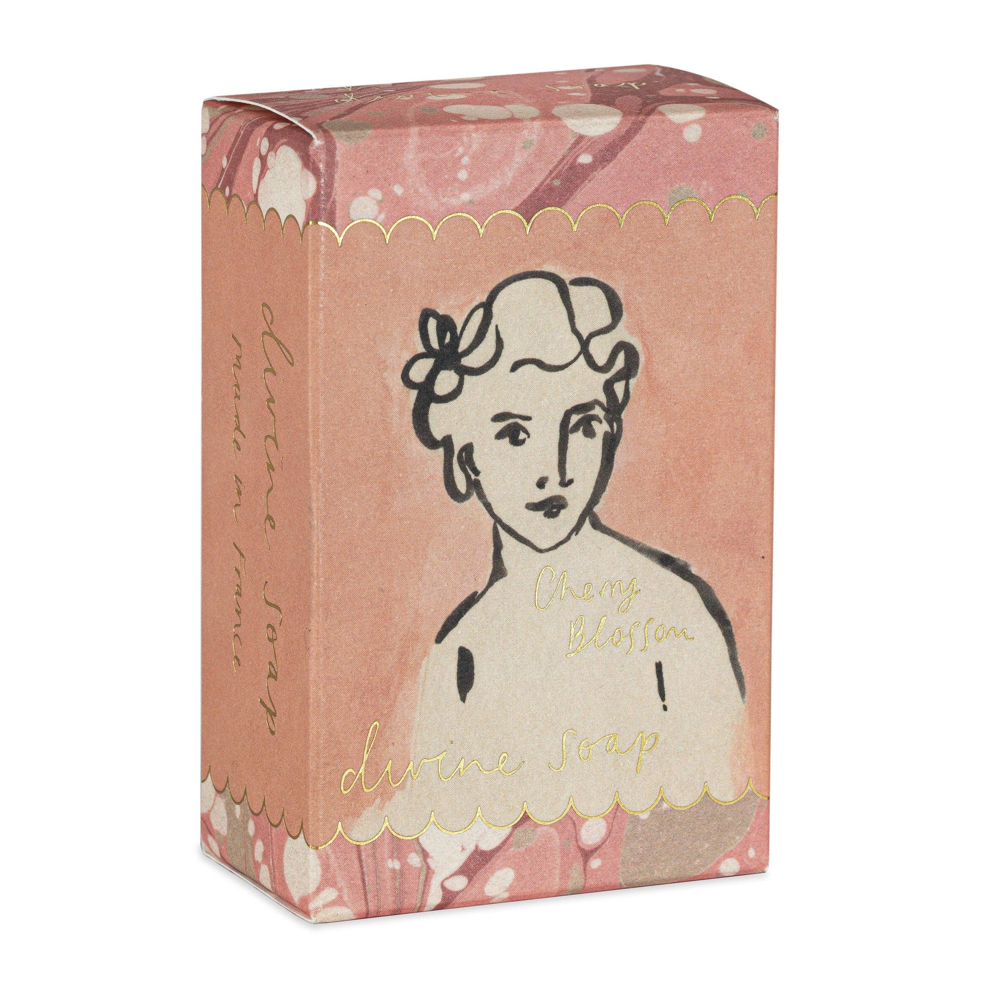 Die Handseife 'Cherry Blossom' (150 g) von Archivist Gallery kommt in einer rosa marmorierten Verpackung mit einem goldenen Wellenrand und einer schwarzen Strichzeichnung eines Frauengesichts auf der Vorderseite.