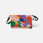 Die Notabag | 'Flow' Leichte Umhängetasche von Notabag ist eine farbenfrohe Umhängetasche mit einem abstrakten Muster in grün, pink, lila, rot, gelb und blau. Sie verfügt über einen schwarzen verstellbaren Gurt, einen Henkelausschnitt auf der Klappe und ein sichtbares Notabag Logo-Tag.