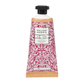 Eine 50-ml-Tube William Morris at Home 'Acorn' Handcreme mit rosa und weißem Blumendesign, schwarzer Kappe und beiger Basis. Auf dem Etikett steht, dass es sich um eine vegane Handcreme handelt.