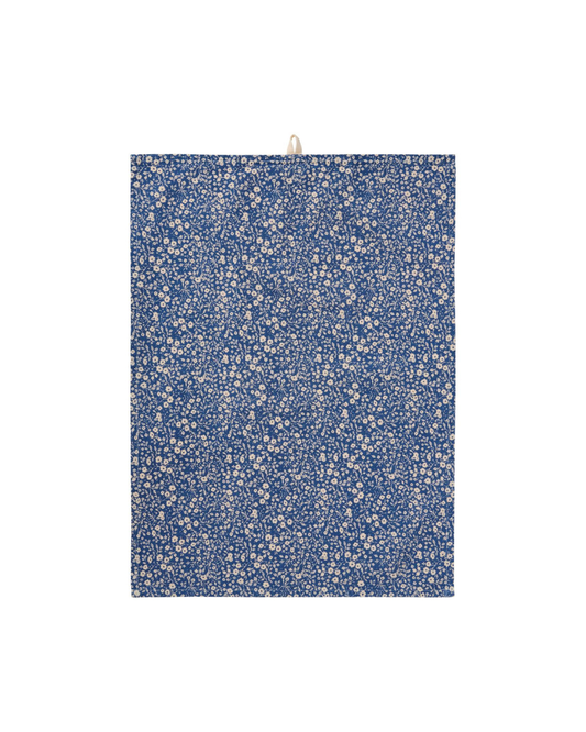 Das Ib Laursen Geschirrtuch 'Paula' ist ein 50 x 70 cm großes, florales Baumwollgeschirrtuch mit blauem Hintergrund, dichtem weißen Blumenmuster und einer Aufhängeschlaufe oben. Es besteht aus 100% Baumwolle und wird flach aufgehängt. Marke: IB Laursen.