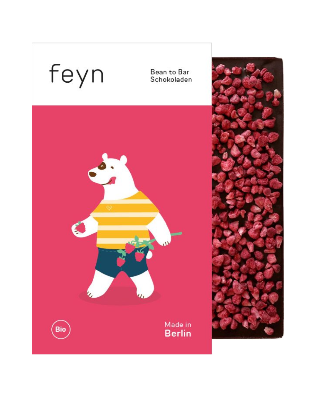 Ein Schokoladenriegel, der teilweise in eine Verpackung eingewickelt ist, die einen weißen Bären in einem gelb gestreiften Hemd zeigt, der Himbeeren auf einem rosa Hintergrund hält. Feyn | Dunkle Schokolade mit Himbeeren ist mit Himbeerstückchen bestreut. Text: Feyn, Bean to Bar Schokoladen, Made in Berlin.