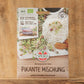 Eine Packung Bio Keimsprossen Saatgut 'Pikante Mischung' von Sperli liegt auf einer Holzfläche aus. Auf der Packung sind Keimsprossen mit Reis und Gemüse abgebildet, zusammen mit Bio- und Qualitätssiegeln.