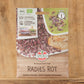 Eine Packung Bio Keimsprossen Saatgut 'Radies Rot' von Sperli ist auf einer Holzfläche ausgestellt, auf der Abbildungen von roten Sprossen auf Brot und in einer Schale sowie Bio- und Zertifizierungssymbole zu sehen sind.