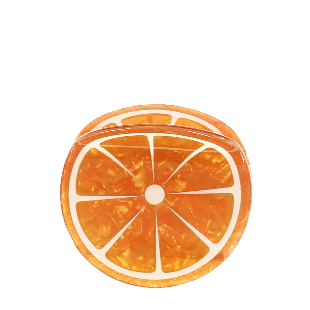 Die Rex B2B - Europe Haarklammer in Orange zeichnet sich durch ein transparentes Acryl aus, das von einer orangefarbenen Scheibe inspiriert ist, mit einer glänzenden Oberfläche und weißen Segmentlinien, die vor einem weißen Hintergrund gezeigt werden.