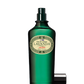 Ein grüner Glasflakon von Ach.Brito Eau de Cologne | Lavander 100 ml mit Sprühkopf und schwarzer Kappe in der Nähe, mit einem cremefarbenen Etikett mit dekorativen Rändern.