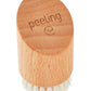 Die Croll & Denecke Gesichtsbürste aus Holz für Peeling & Massage ist eine kleine, ovale Gesichtsbürste aus Buchenholz mit weichen, weißen Borsten, dem eingravierten Wort "Peeling" und einem Spiralsymbol.