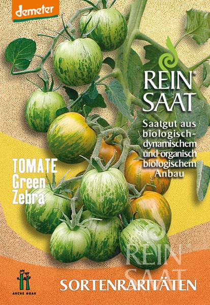 Eine Saatgutpackung von Reinsaat mit der Aufschrift "Tomate 'Green Zebra'" zeigt grün und gelb gestreifte Solanum lycopersicum-Tomaten am Rebstock, die als biologisch und biodynamisch bezeichnet werden. Der Hintergrund zeigt ein gelbes und beiges Muster.