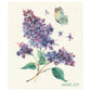 Illustration von lila Fliederblüten, grünen Blättern, einem Schmetterling und Blütenblättern. "MORE JOY" erscheint in grüner Schrift unten rechts - zu sehen auf More Joy Home | 'Sirene' Biologisch abbaubares Schwammtuch von More Joy.
