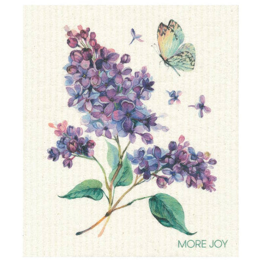 Illustration von lila Fliederblüten, grünen Blättern, einem Schmetterling und Blütenblättern. "MORE JOY" erscheint in grüner Schrift unten rechts - zu sehen auf More Joy Home | 'Sirene' Biologisch abbaubares Schwammtuch von More Joy.
