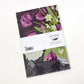 Eine florale Grußkarte mit lila Tulpen und weißen Blüten, abgebildet mit dem Art Angels-Logo und mit Barcode in England gedruckt. Perfekt zu kombinieren mit der Tasse mit Tulpen oder dem Art Angels Notizbuch 'Tulpen und Narzissen' von Angie Lewin.