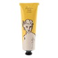 Eine gelbe und beigefarbene Tube Archivist | 'Sheabutter' Handcreme von Archivist Gallery, die auf der Vorderseite eine einfache Strichzeichnung eines Frauengesichts zeigt.