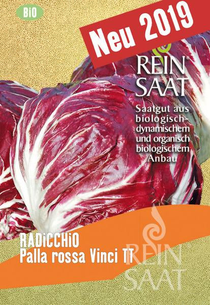 Eine Saatgutpackung zeigt zwei Köpfe von rotem und weißem Radicchio mit der Aufschrift "Reinsaat | Radicchio 'Palla rossa Vinci TT'" und einem roten "Neu 2019"-Banner. Der Text betont den biologischen und biodynamischen Anbau von Cichorium intybus.