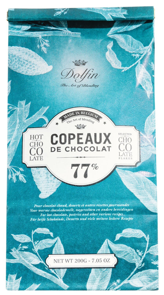Eine blaue Verpackung von Venchi Dolfin | Trinkschokolade Zartbitter 77 % – feine dunkle Schokoladenraspeln (Kakaogehalt: 77 %) für eine vollmundige Trinkschokolade – verziert mit eleganten weißen Pflanzenillustrationen. Nettogewicht: 200 g (7,05 oz).