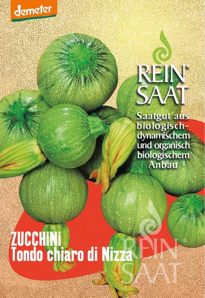 Eine Saatgutpackung enthält mehrere runde, hellgrüne Zucchini mit strukturierter Oberfläche. Auf dem Etikett steht: Reinsaat | Zucchini 'Tondo chiaro di Nizza' - Saatgut aus biologisch-dynamischem und organisch-biologischem Anbau.